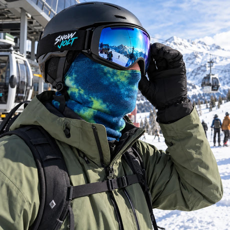 Skier adjusting goggles at the gondola station wearing a blue Snow Jolt balaclava